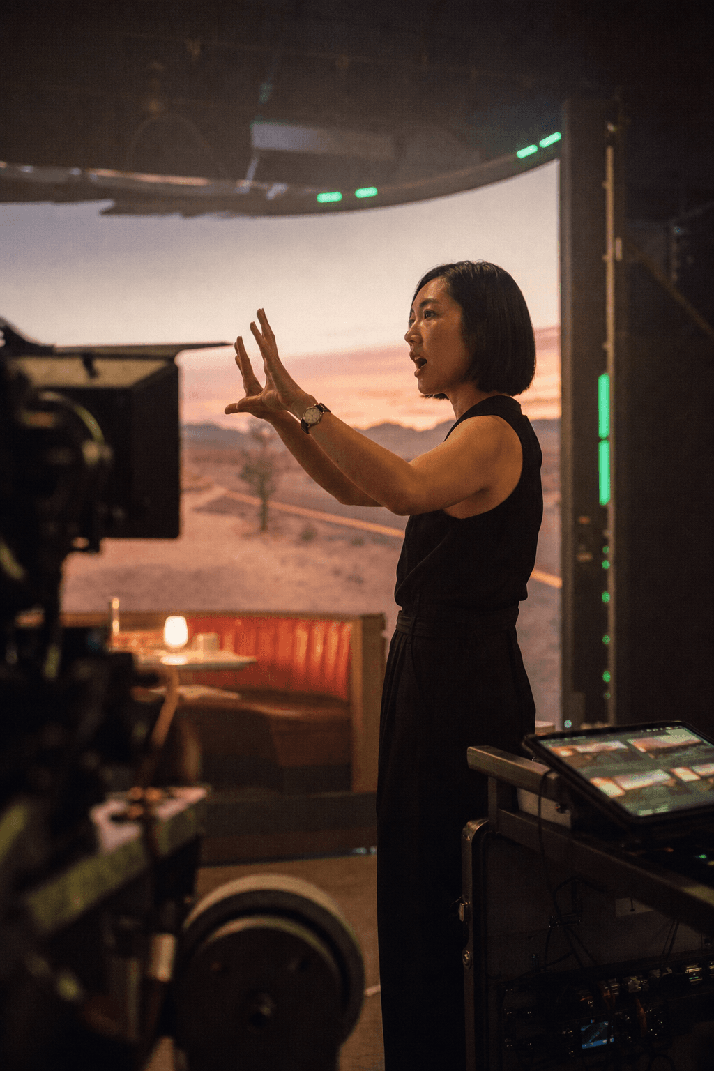 A director framing a shot inside an LED volume where a dusk desert bleeds into the practical set